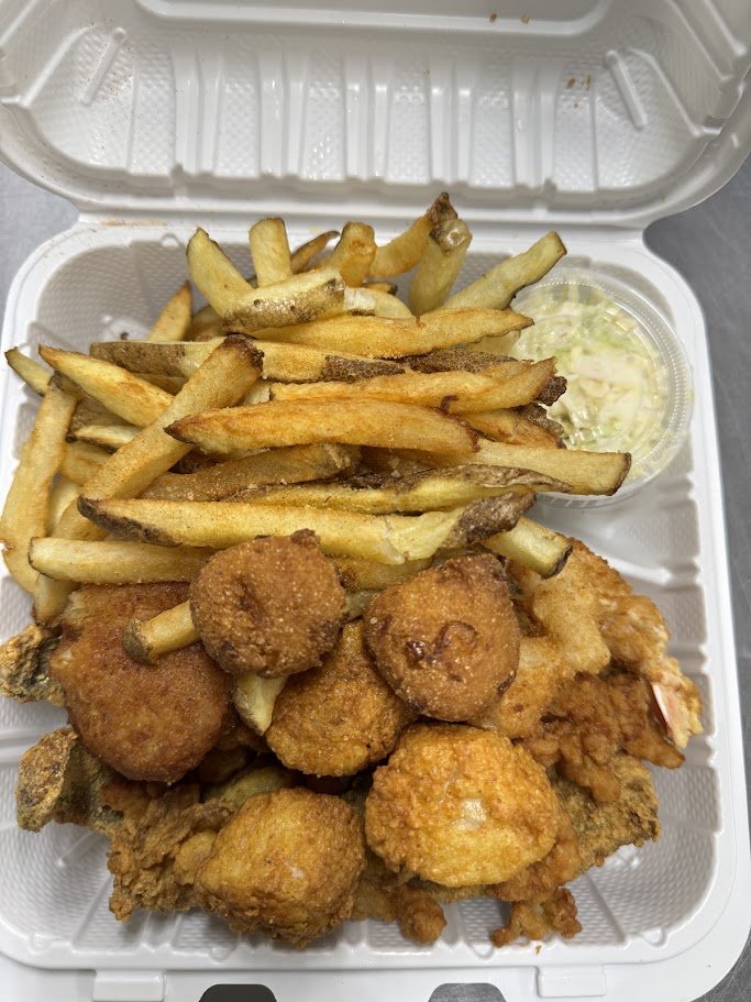 Crabs and fried fish on white plates.