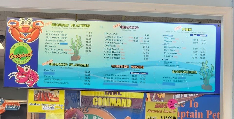 Menu board with crab house selections.